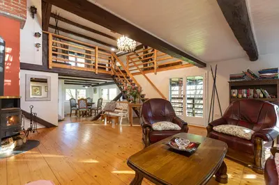 a living room with leather chairs and a table at Hiša Jaglenka in Ponikva