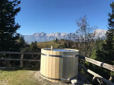 a wooden barrel on a fence with mountains in the background at Chalet Tisa Velika Planina in Stahovica