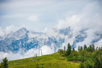 a view of a mountain with clouds and trees at Chalet Tisa Velika Planina in Stahovica