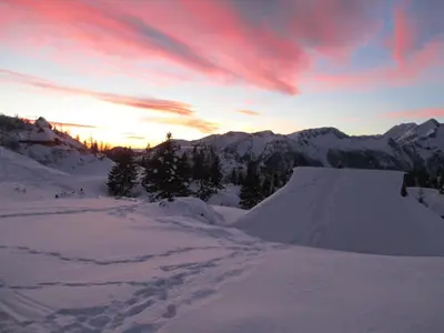 a snow ramp in the snow with a sunset at Chalet Tisa Velika Planina in Stahovica
