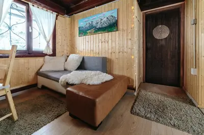 a living room with a couch and a table at Chalet Tisa Velika Planina in Stahovica