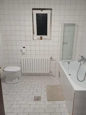 a bathroom with a toilet and a tub and a sink at KaTi Hiša