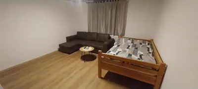 a living room with a couch and a bed at KaTi Hiša