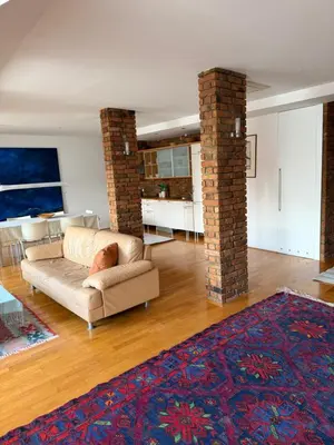 a living room with a couch and a brick pillar at Ekoviki in Kranj