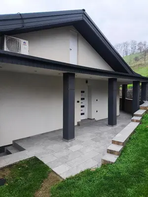 a building with a patio with a air conditioning at Apartmaji Divji vrt in Lendava