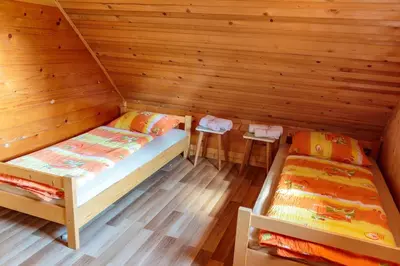 a room with two beds in a cabin at Mountain lodge Pokljuka in Bohinjska Bistrica
