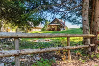 a wooden fence in front of a house at Mountain lodge Pokljuka in Bohinjska Bistrica