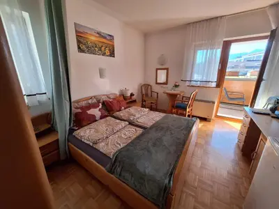 a bedroom with a bed and a table and chairs at Mia's room in Zreče