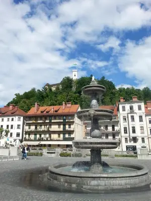 a fountain in a square with buildings in the background at Ljubljanica Apartment in Ljubljana