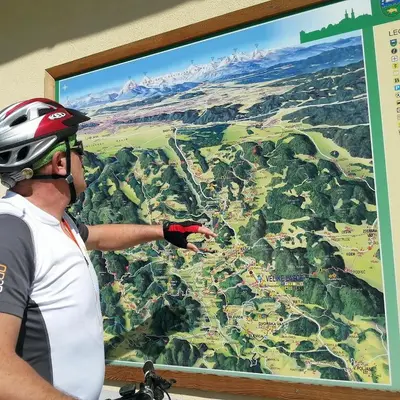a man in a helmet pointing at a map at Ljubljanica Apartment in Ljubljana