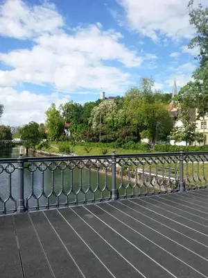 a metal railing on a bridge over a river at Ljubljanica Apartment in Ljubljana