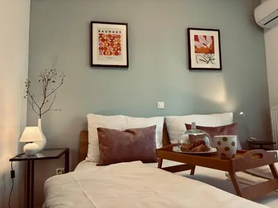 a bedroom with a bed with a tray of food on it at Ljubljanica Apartment in Ljubljana