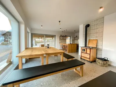 a kitchen with a wooden table in a room at KOČA ODMEV Obolno in Ivančna Gorica