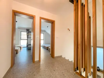 a hallway with two doors leading to a bedroom at KOČA ODMEV Obolno in Ivančna Gorica