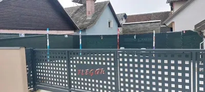 a black fence in front of a house at Flegarrooms in Cerklje na Gorenjskem
