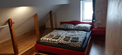 a small room with a bed and a staircase at Flegarrooms in Cerklje na Gorenjskem