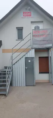a building with a ramp and a door in front at Flegarrooms in Cerklje na Gorenjskem