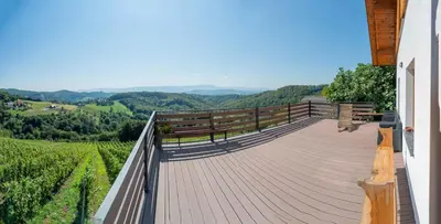 a deck with a bench and a view of the mountains at Holiday home in Trzisce - Kranjska (Krain) 54981