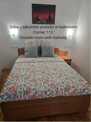 a bedroom with a bed with a quilt on it at Cozy Nook Stays, Ski rent, med Roglo in Termami Zreče, in Zreče