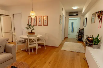 a living room with a table and a couch at Anur Apartment II in Ptuj