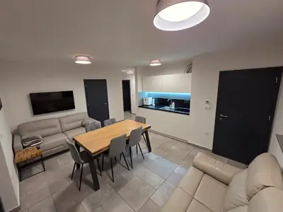 a living room with a table and a couch at Apartma JOŠT GOLTE in Mozirje