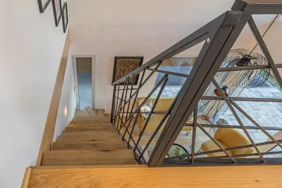 a staircase in a house with a glass wall at Počitniška hiša Gorski Šepet Bled in Bled