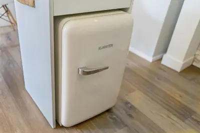 a refrigerator is sitting next to a counter at Elegant Castle Nook in Ljubljana