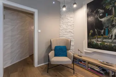 a room with a chair and a painting on the wall at Elegant Castle Nook in Ljubljana
