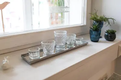 a tray of glasses sitting on a window sill at Elegant Castle Nook in Ljubljana