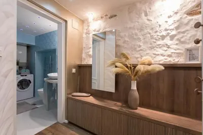 a bathroom with a mirror and a vase with a plant at Elegant Castle Nook in Ljubljana