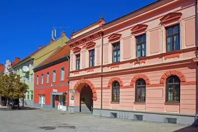a large brick building with an arch in a street at Vila Trate with Shared Pool and Garden in Ljutomer