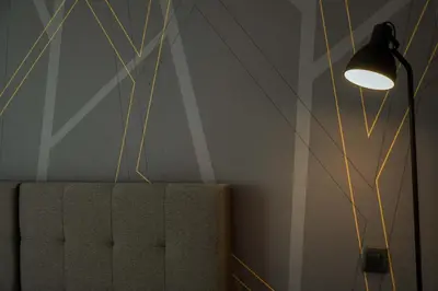 a lamp sitting next to a couch in a room at Guest House Tri Zvezde in Kočevje