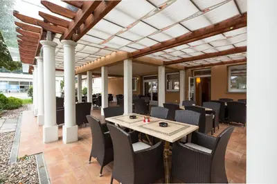 an outdoor patio with a table and chairs at Guest House Tri Zvezde in Kočevje