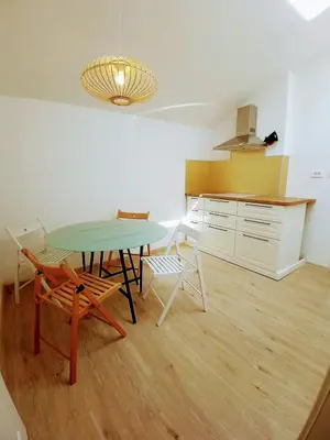 a kitchen with a table and chairs in a room at House Godec in Ljubljana