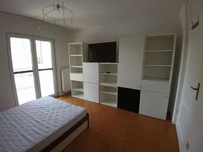 a bedroom with a bed and a flat screen tv at House Godec in Ljubljana