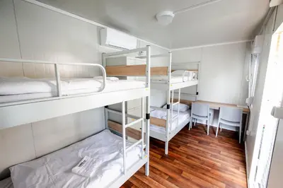 a room with three bunk beds and a table at LYNX PRO - Basecamp units in Rove