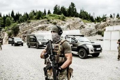 a man in a military uniform holding a gun at LYNX PRO - Basecamp units in Rove