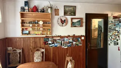 a dining room with a table and a wooden wall at Room Pstina in Slappe dʼIdria