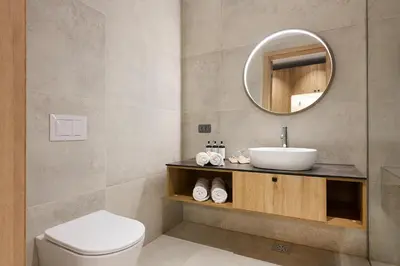 a bathroom with a sink and a mirror at Butični gorski spa hotel Rimski vrelec in Kotlje