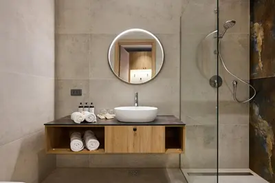 a bathroom with a sink and a mirror at Butični gorski spa hotel Rimski vrelec in Kotlje