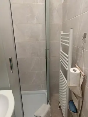 a bathroom with a shower with a toilet and a sink at Holiday House with scenic Apartment in Ptuj
