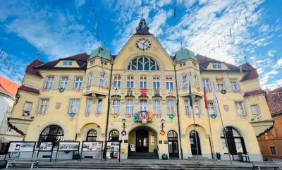 a building with a clock on the front of it at Holiday House with scenic Apartment in Ptuj
