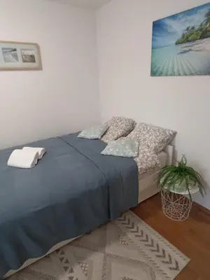 a bedroom with a bed and a painting on the wall at Holiday House with scenic Apartment in Ptuj