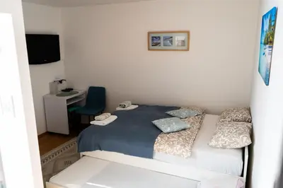 a small bedroom with a bed and a desk at Holiday House with scenic Apartment in Ptuj