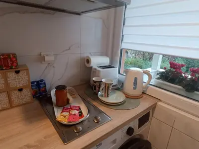 a small kitchen with a tray of food on a counter at Holiday House with scenic Apartment in Ptuj