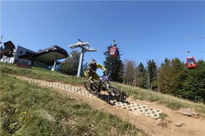 a person riding a bike on a dirt road at Holiday Apartment Bolfenk in Pohorje