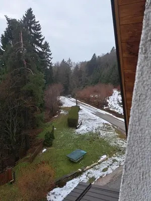 a view of a yard with snow and a road at Gostišče Jelka in Pohorje
