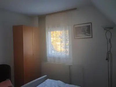 a bedroom with a bed and a window at Gostišče Jelka in Pohorje