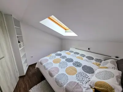 a bedroom with a bed and a skylight at Apartment Doroteja in Podplat