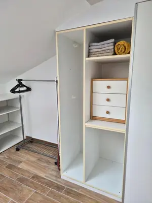 a room with a closet with white shelves at Apartment Doroteja in Podplat